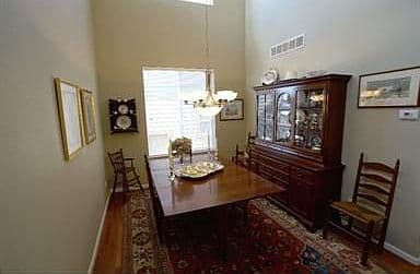 Formal dining space perfect for gatherings under vaulted ceilings.