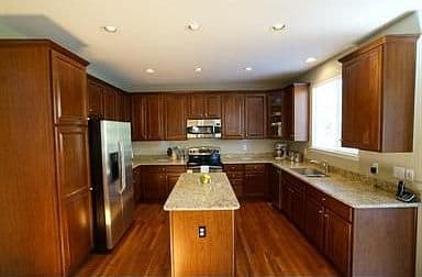 Updated eat-in kitchen with island and gleaming new counters.