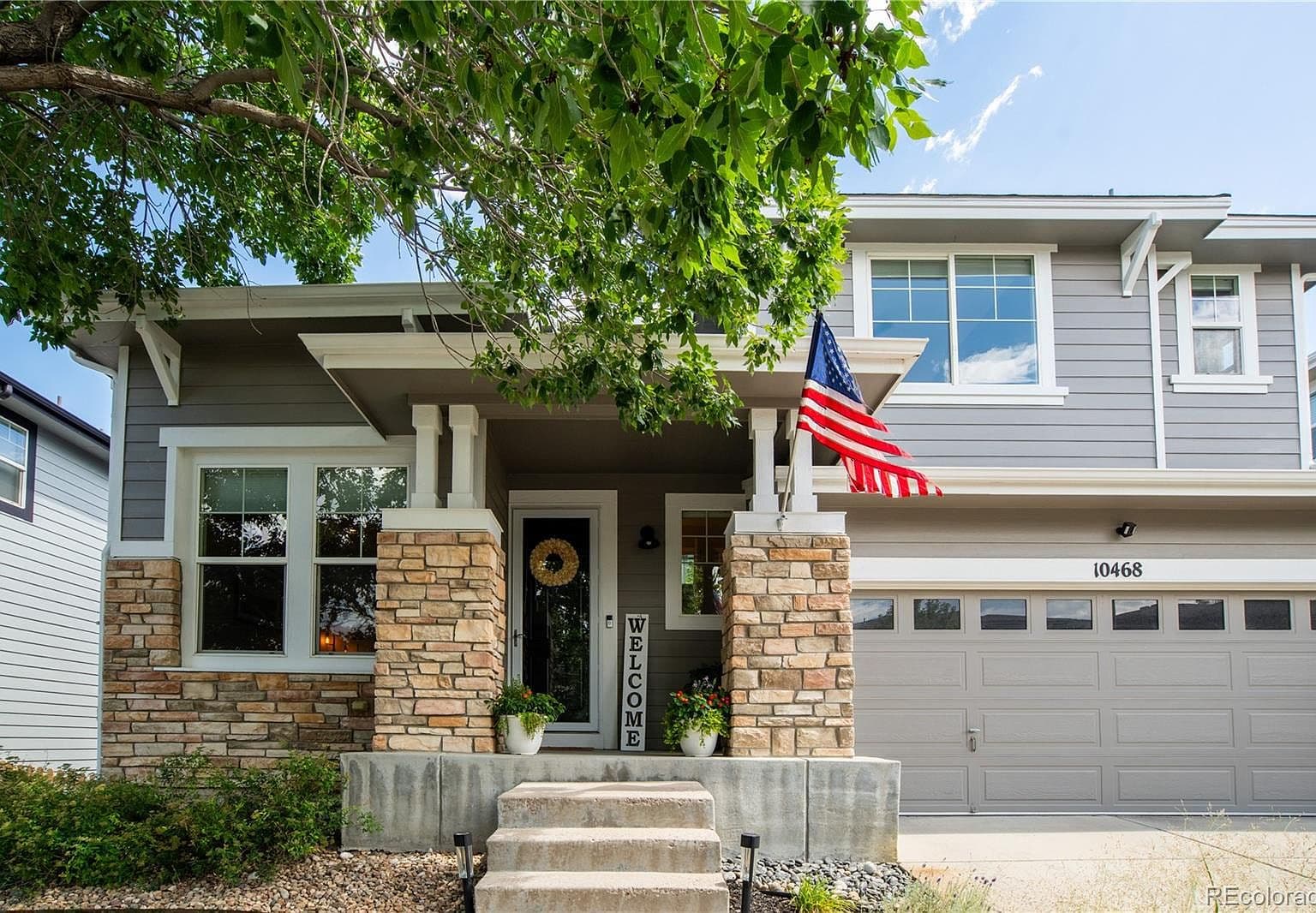 Welcoming covered porch and crisp modern Craftsman facade.