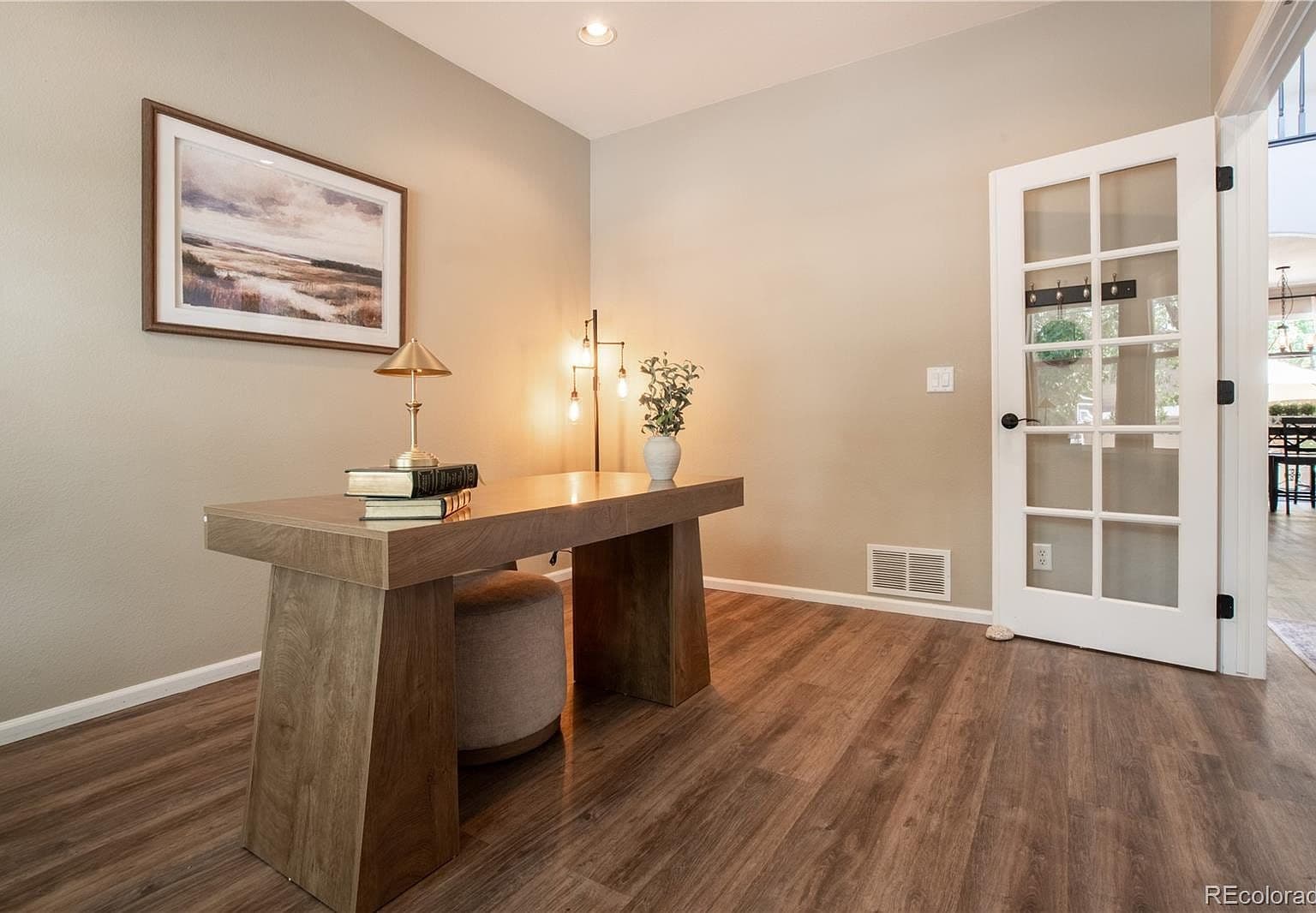 Dedicated office with French doors and stylish new flooring.