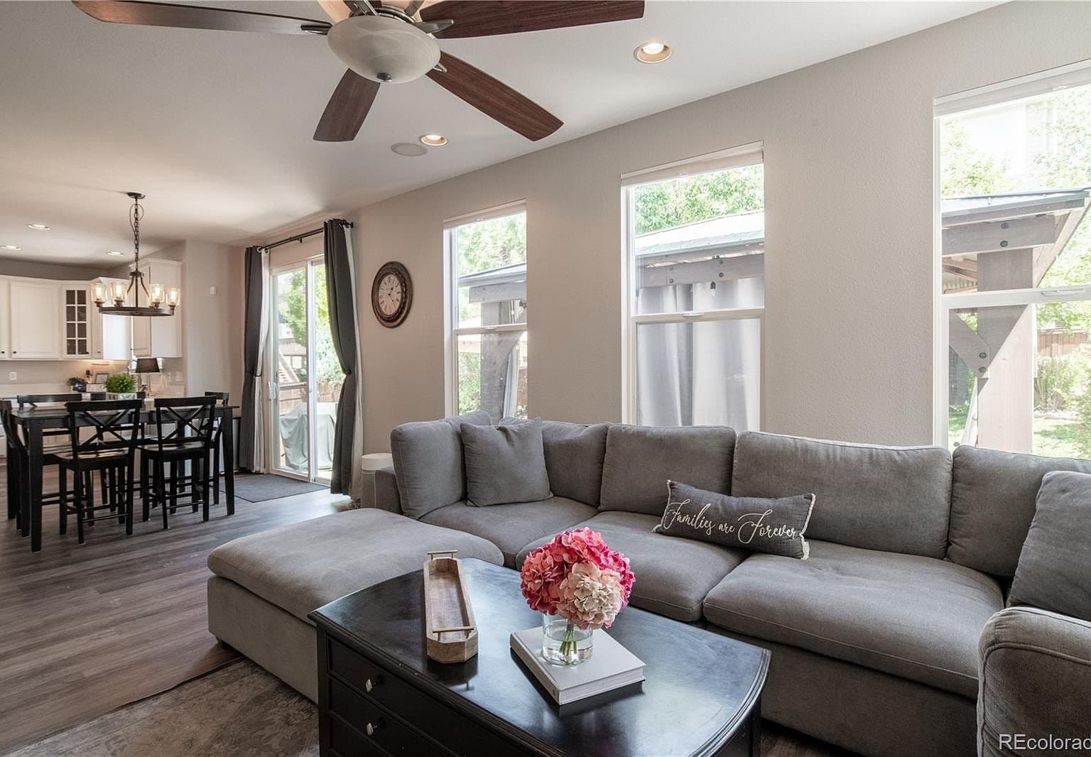 Open-concept great room flows to dining and patio.