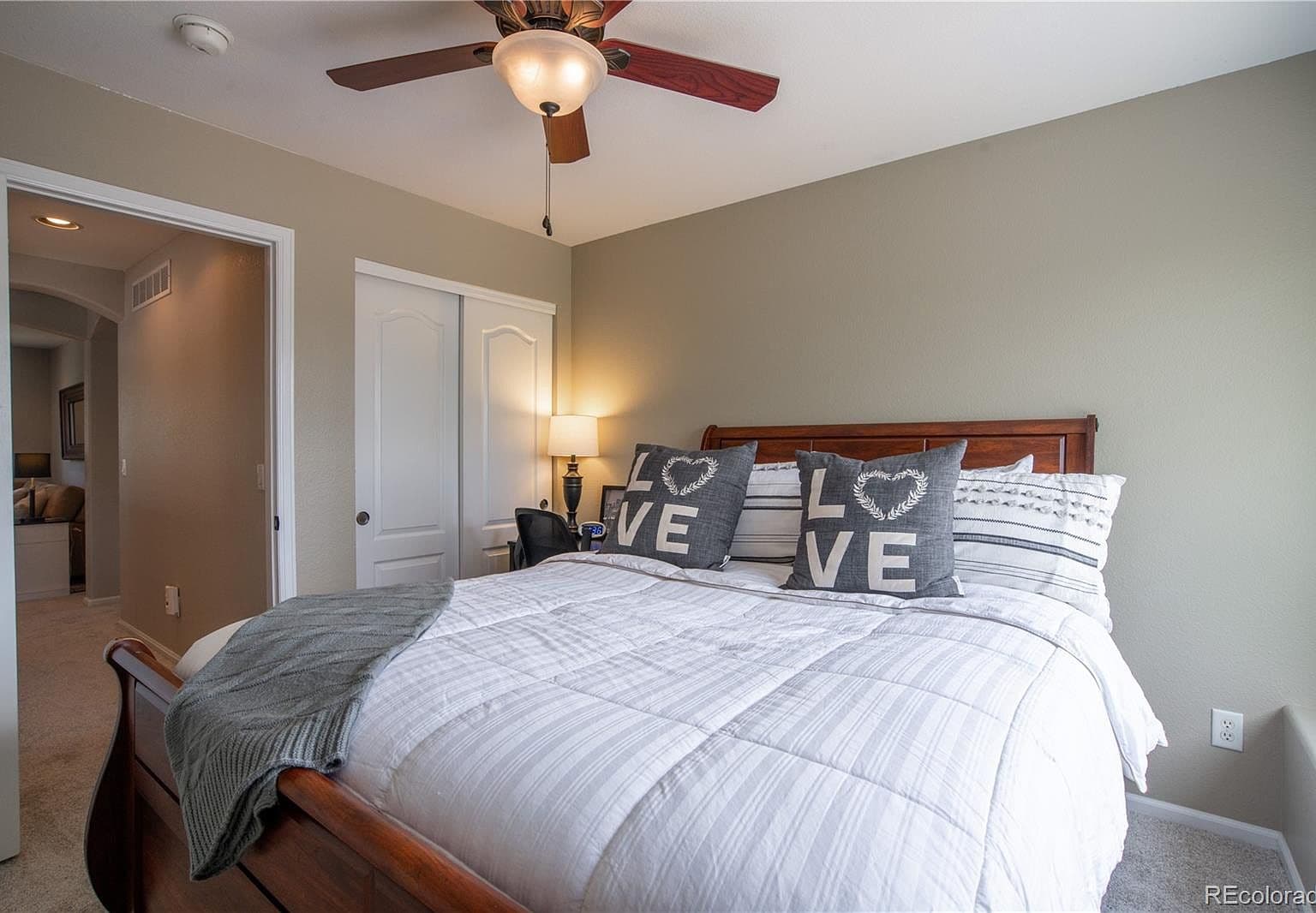 Spacious primary suite with plush carpet and calming tones.