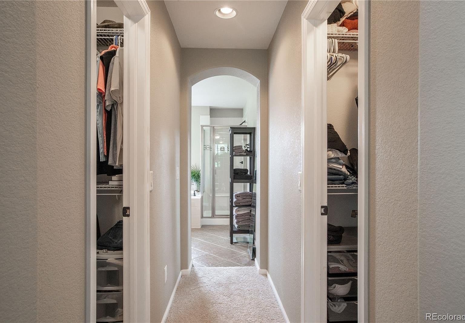 Dual walk-in closets lead to spa-style bath.