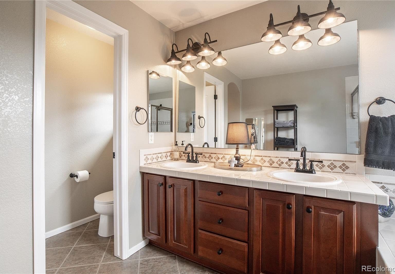Double vanity with ample storage and updated lighting.