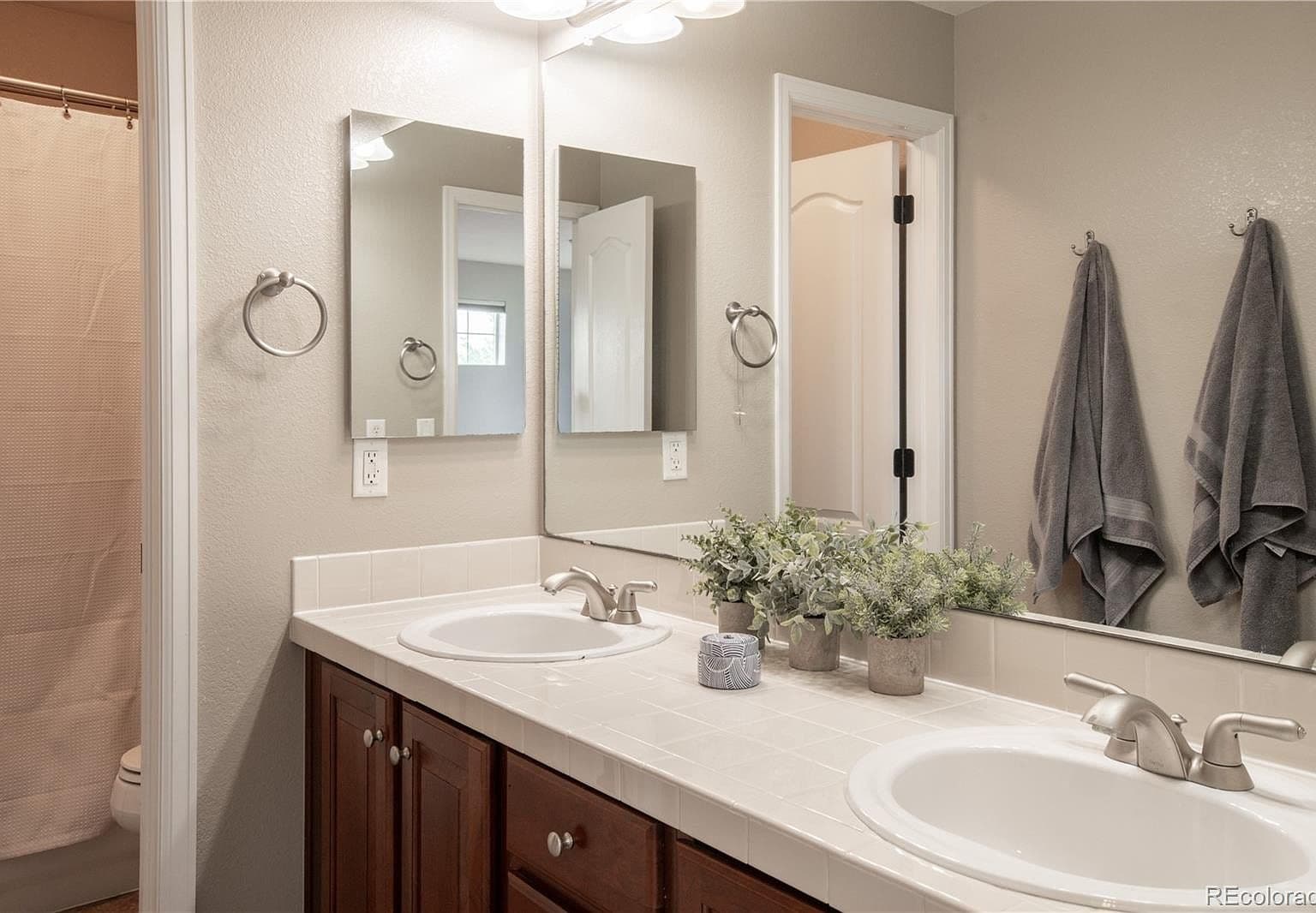Spacious secondary bath with double sinks and shower.
