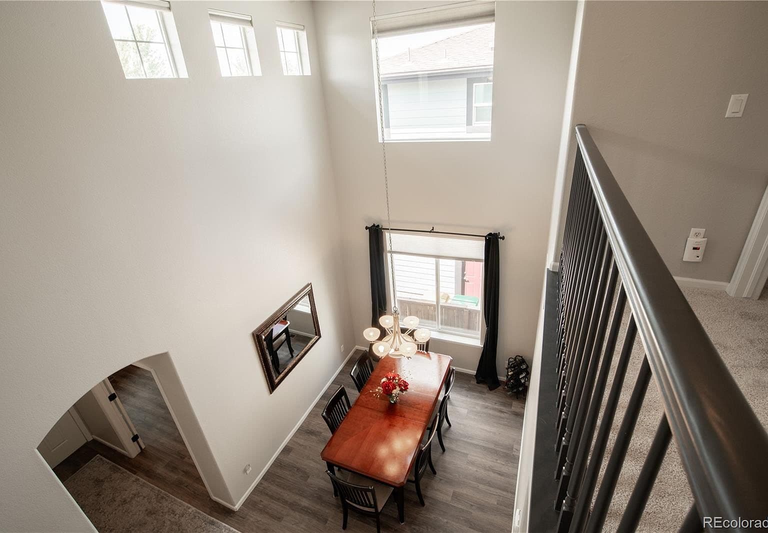Dramatic two-story dining space filled with natural light.