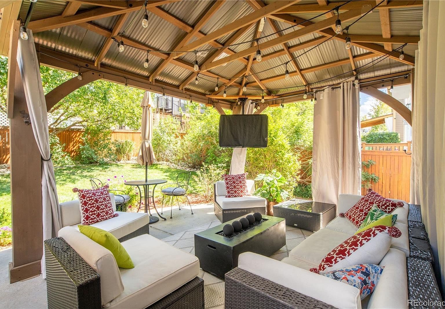 Cozy gazebo lounge with lights—perfect for evenings.