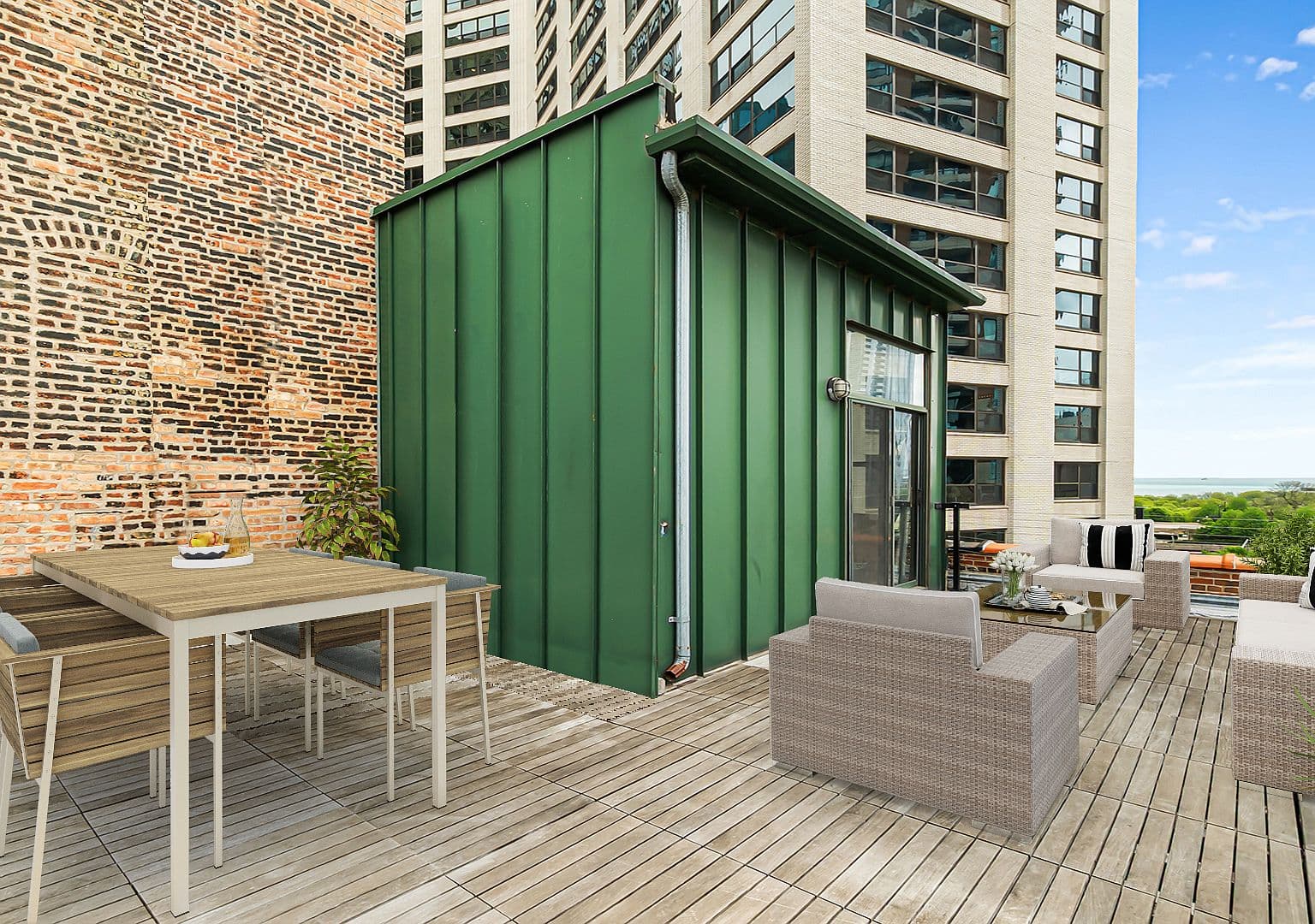 Rooftop dining area beside exposed brick and penthouse access