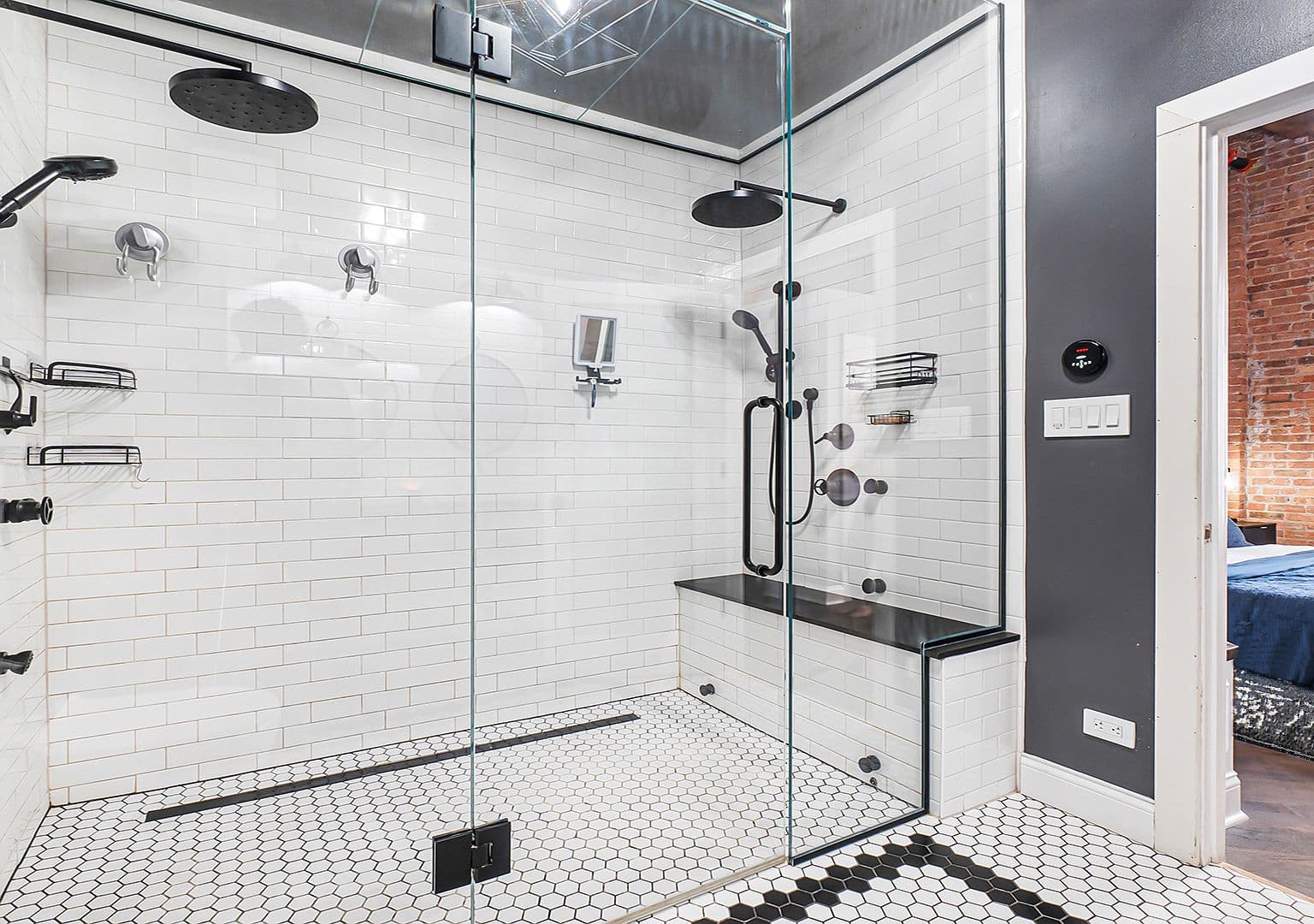 Spa-style walk-in shower with dual rain heads and bench