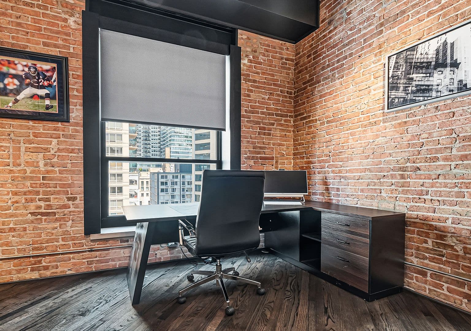 Second bedroom office with exposed brick and skyline windows