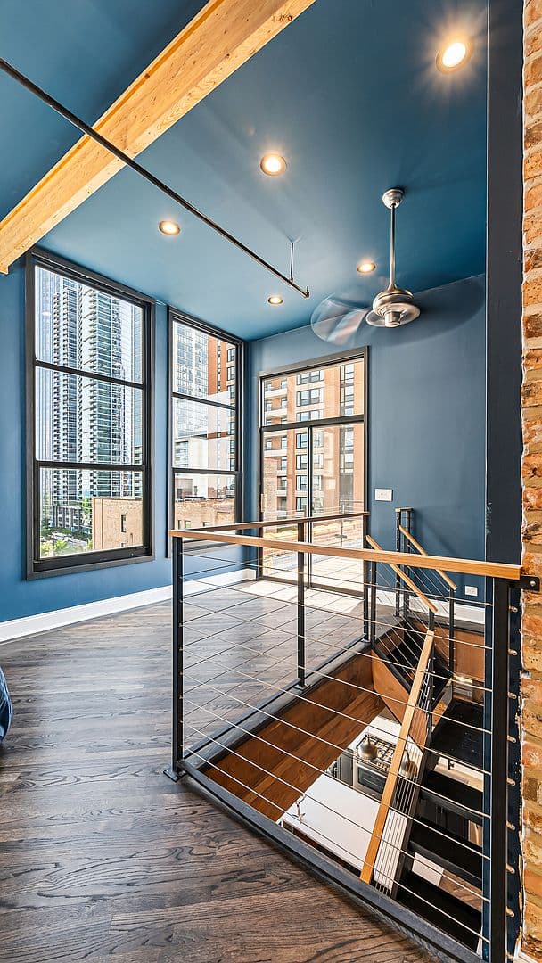 Second-level landing with bold blue walls and open railing