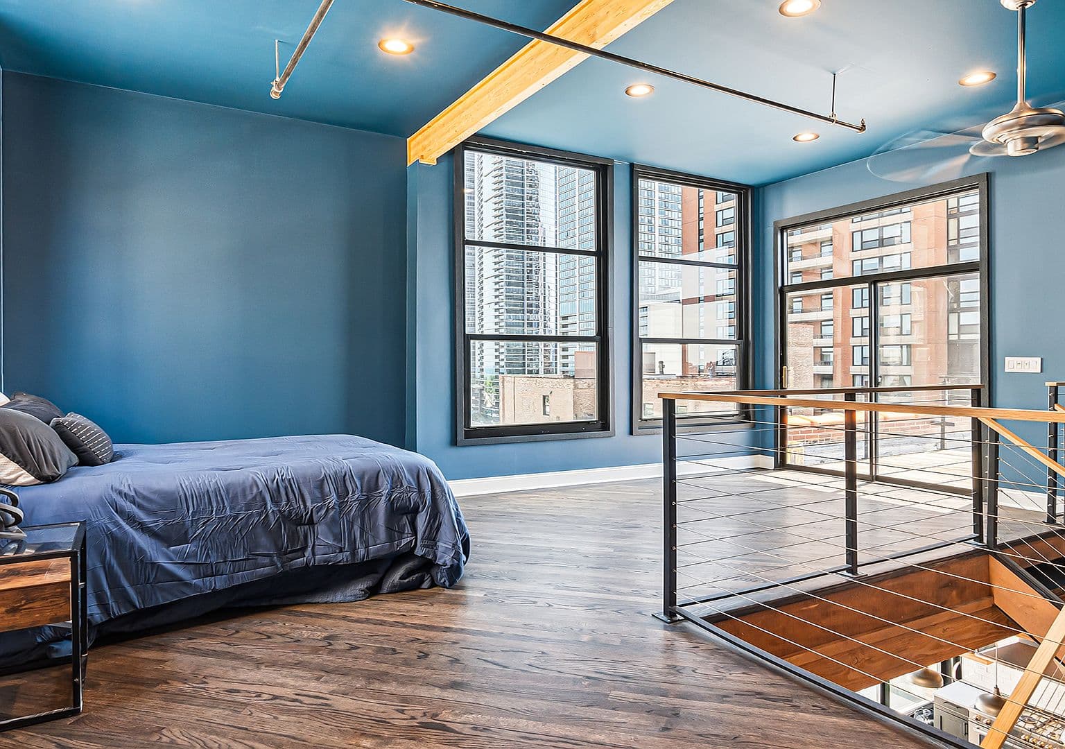 Airy second-level flex space overlooking the rooftop deck