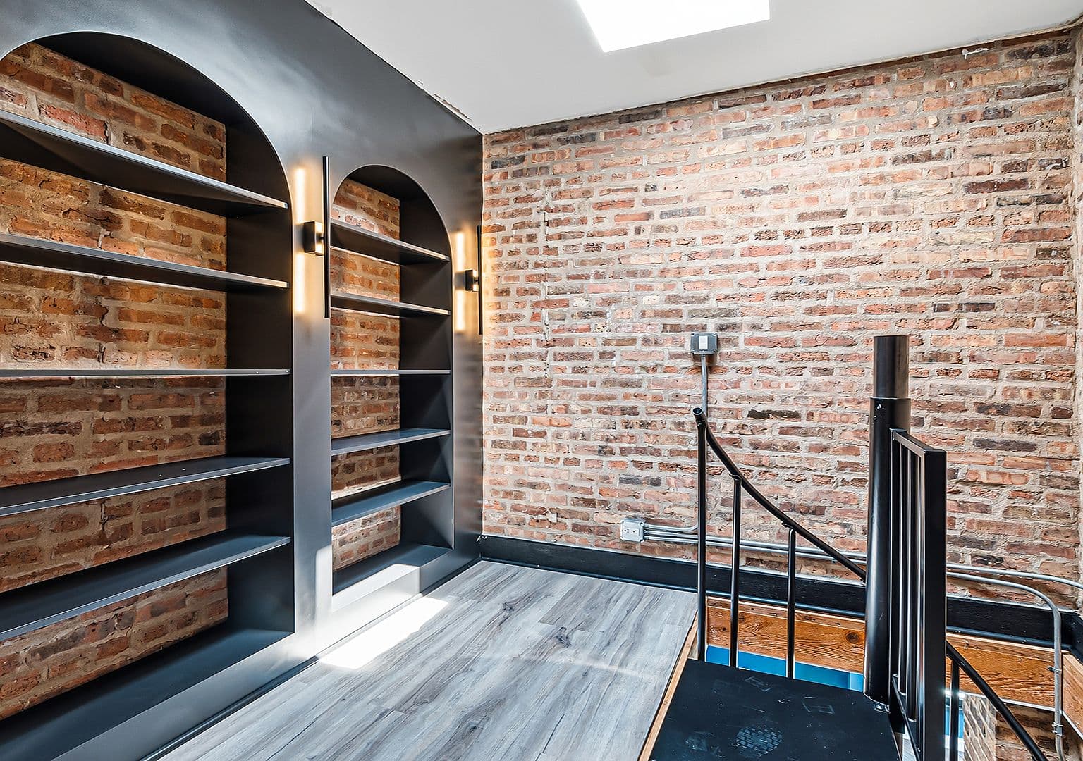 Third-level storage loft with arched built-in shelving