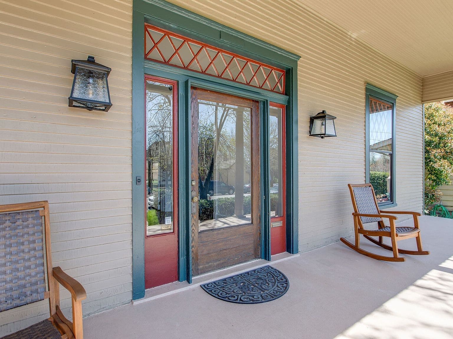 Inviting covered front porch with original Craftsman entry.