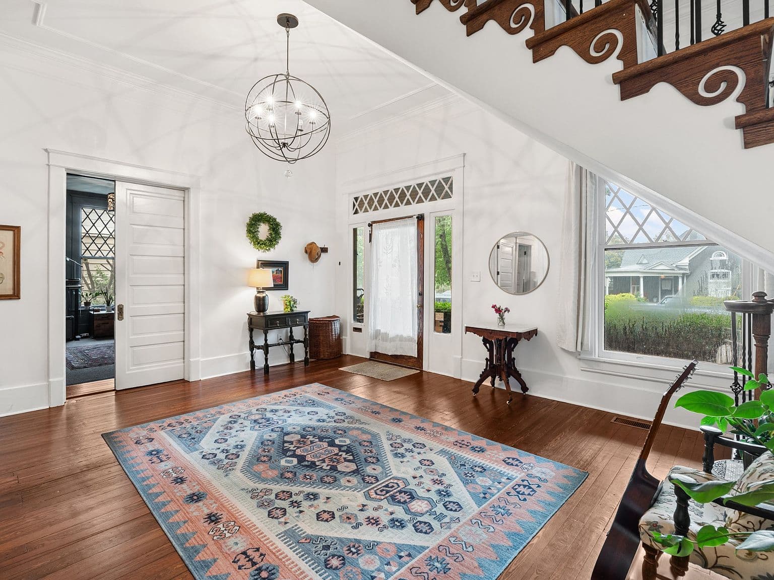 Bright, soaring entry with designer lighting and vintage windows.