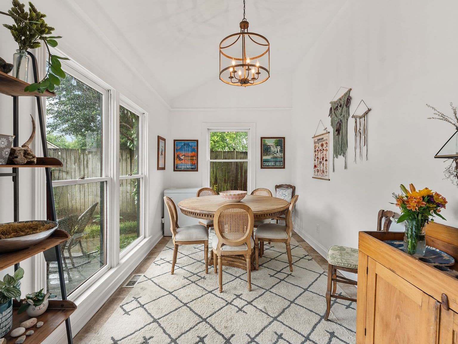 Sunlit dining nook overlooking private fenced backyard patio.