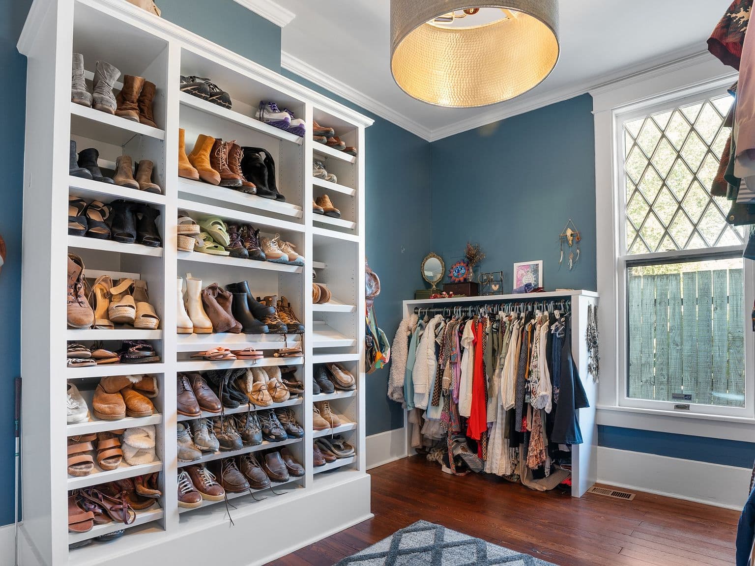 Boutique-style walk-in closet with custom shoe storage.