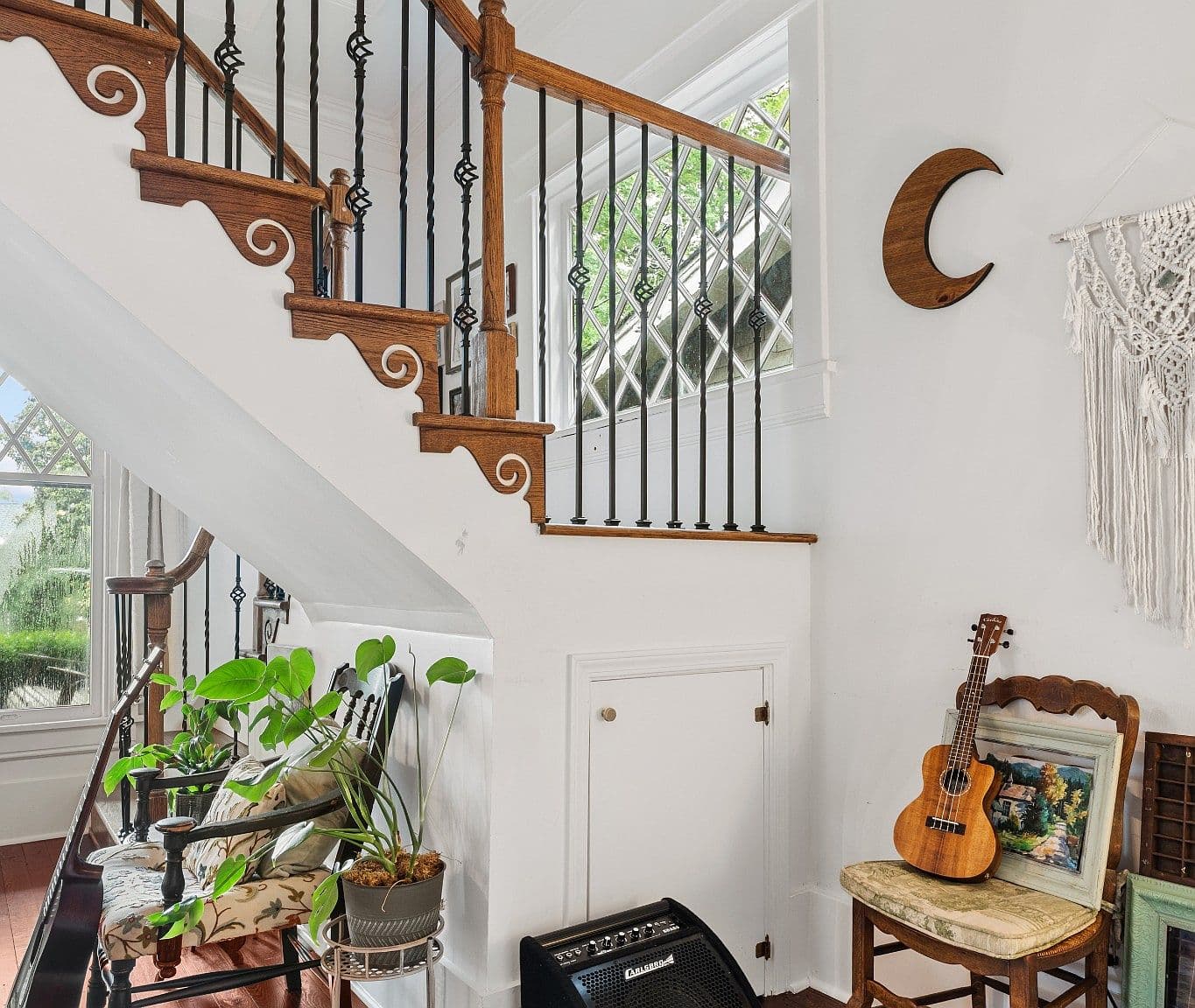 Striking staircase details beside restored heart-pine floors.
