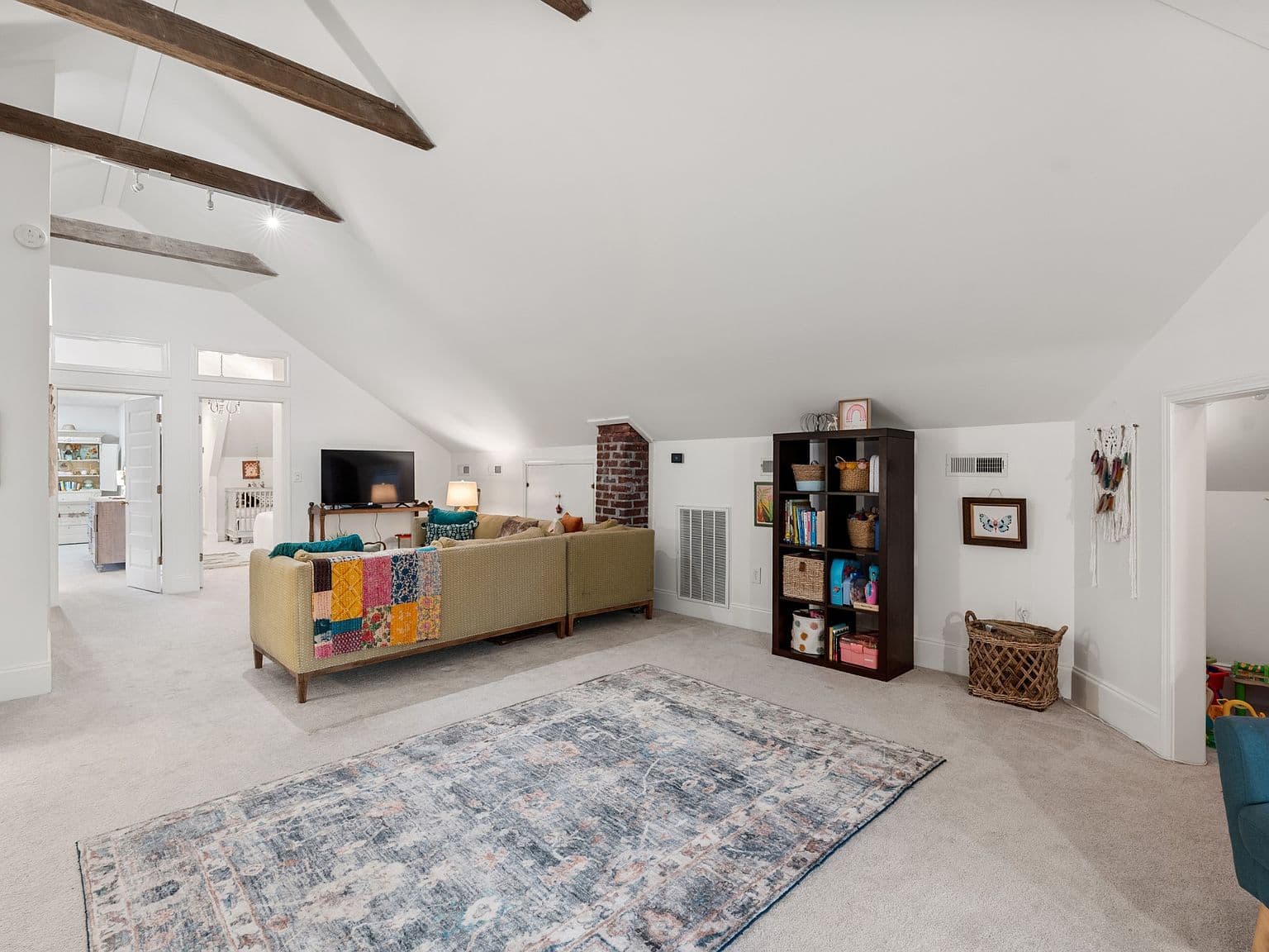 Expansive upstairs bonus room with vaulted ceiling and beams.