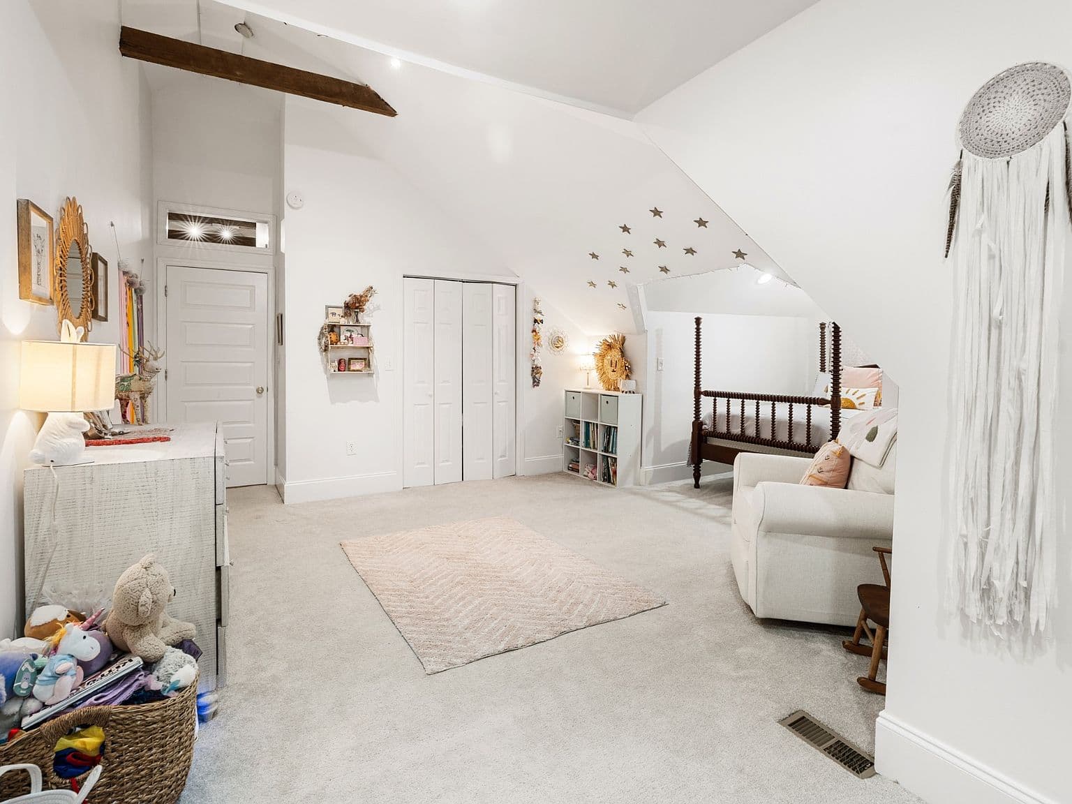 Bright upstairs bonus space with rustic beam and closets.