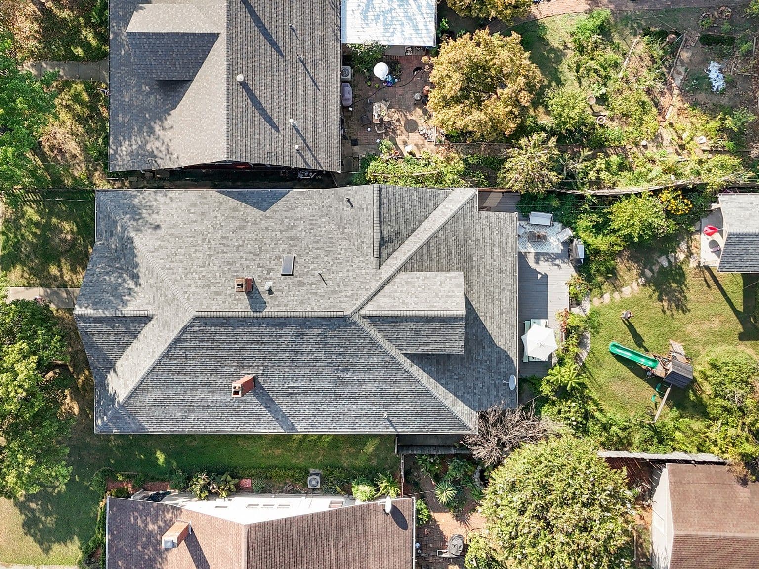 Aerial view showcasing expansive lot, deck, and backyard.