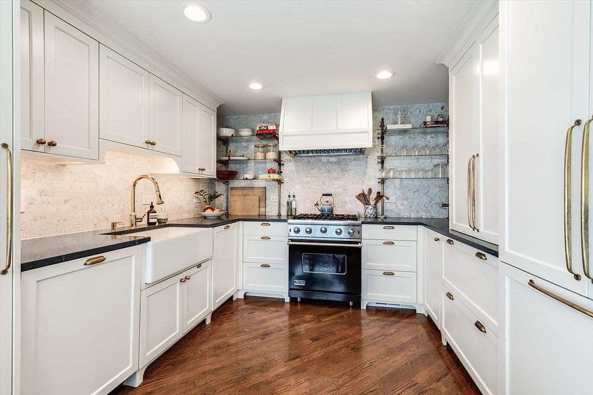 Marble-clad kitchen with custom cabinetry and integrated appliances.
