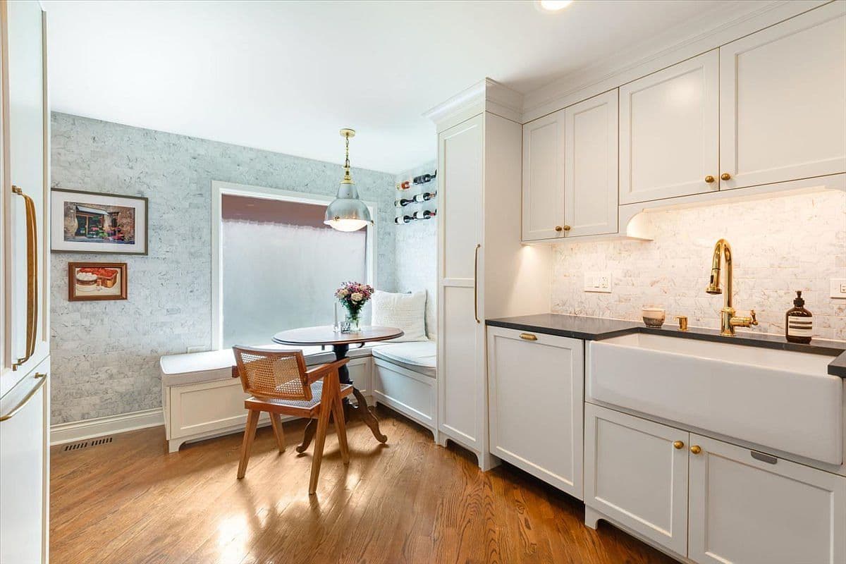 Built-in banquette dining nook with charming custom wine display.