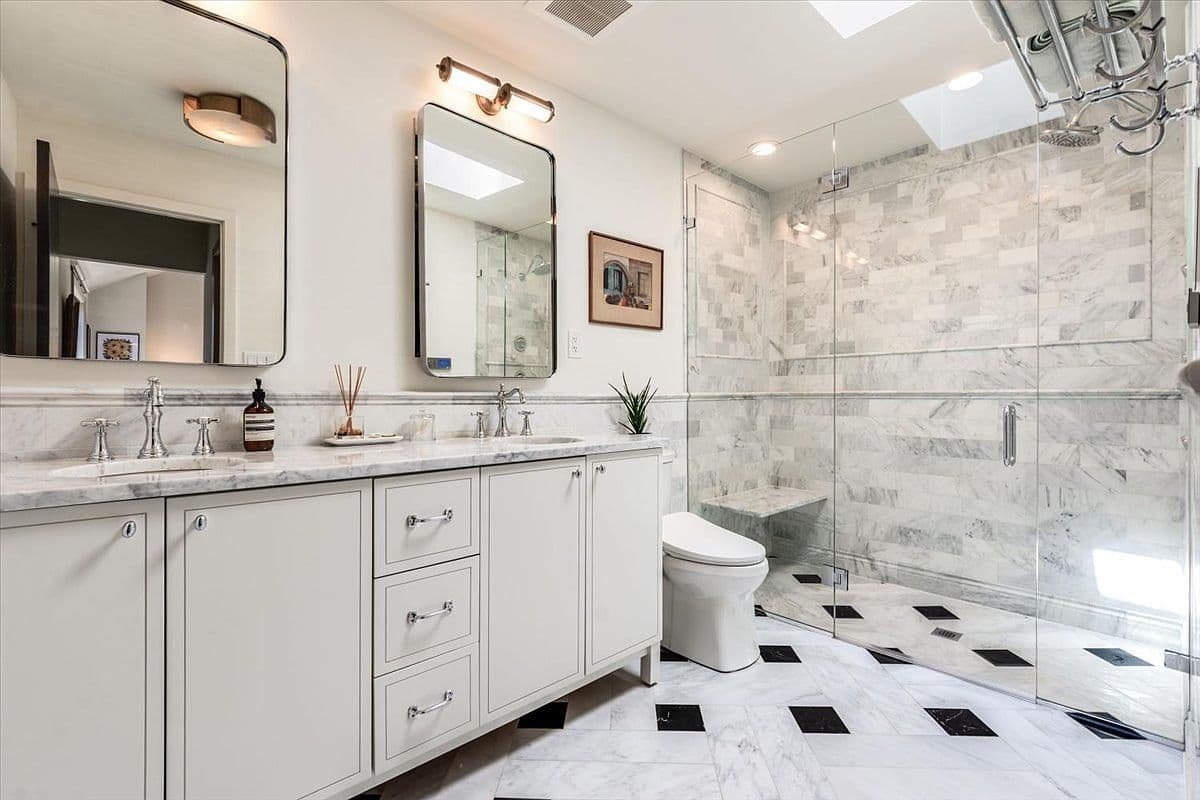 Spa-like marble bath with oversized glass shower.