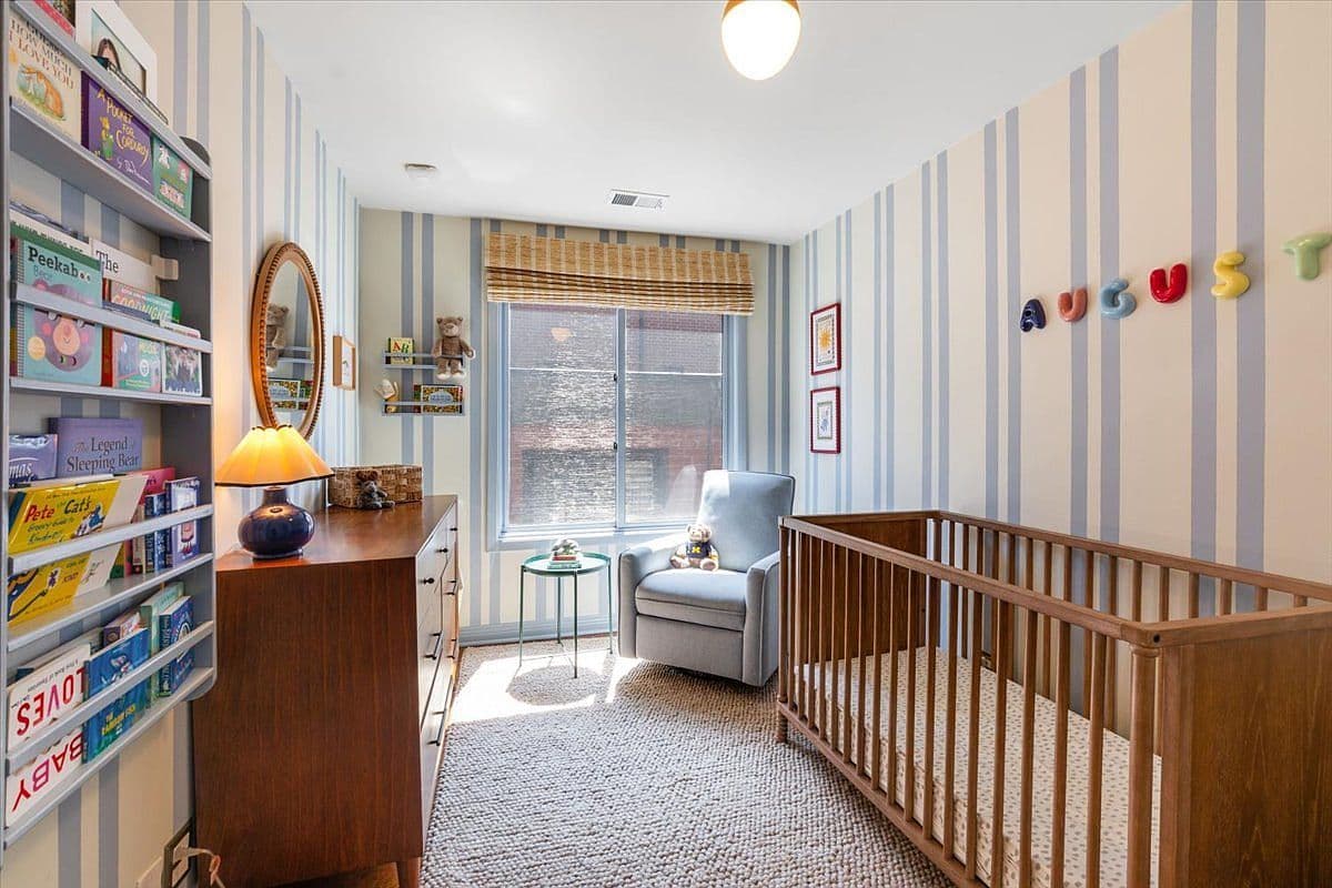 Charming nursery with built-in shelving and sunny window.