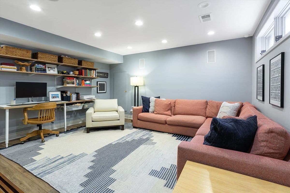 Basement lounge with custom shelving and work-from-home nook.