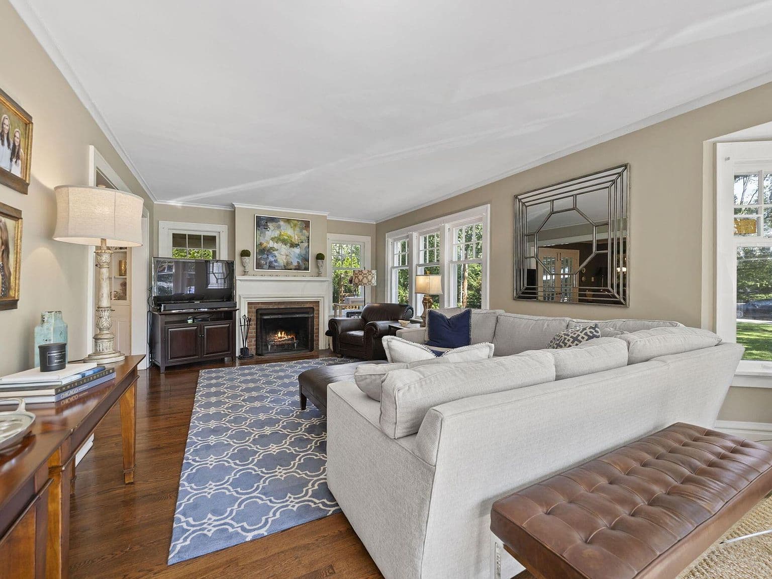 Decorative fireplace and expansive windows create a welcoming lounge.
