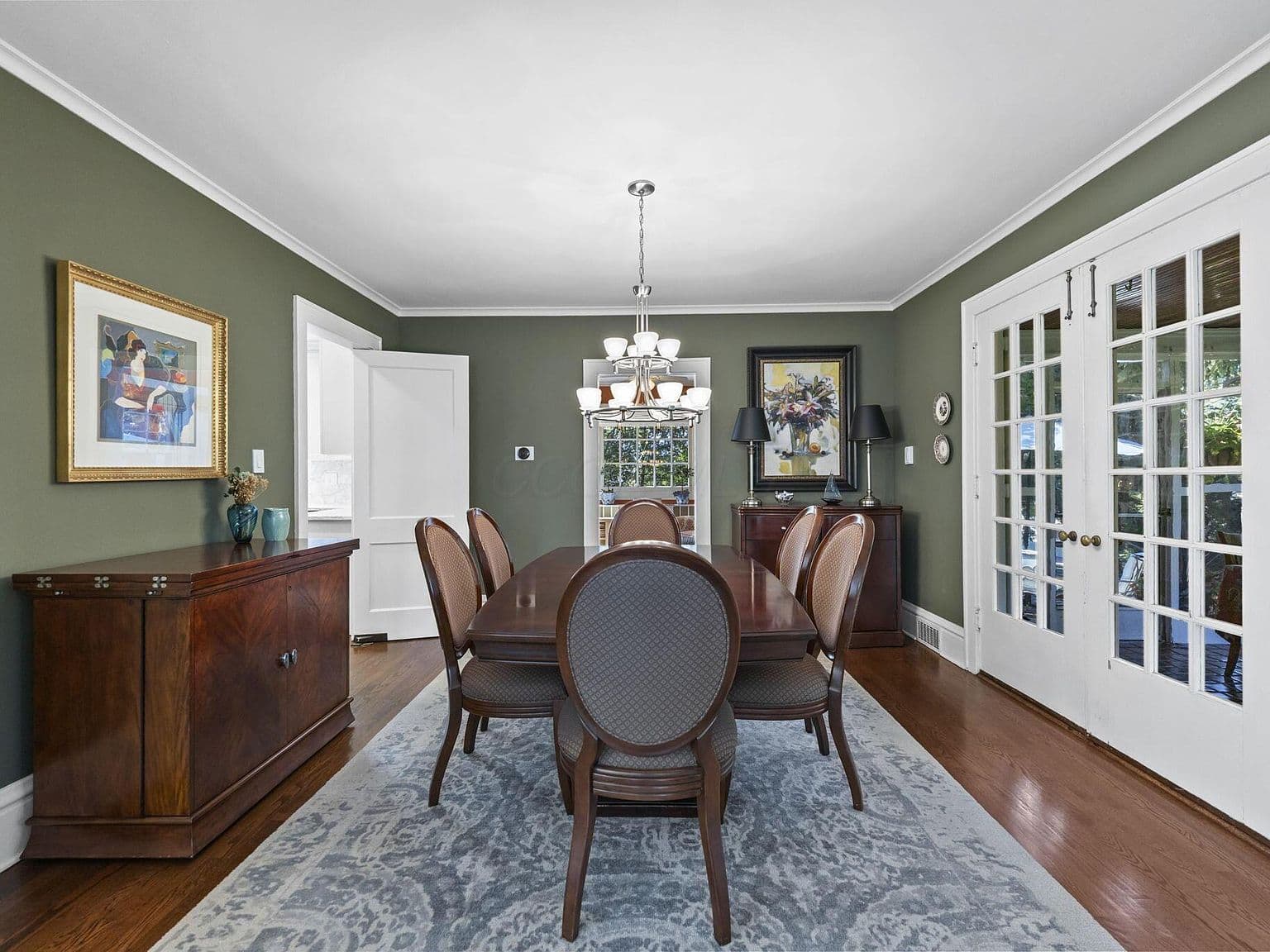 Classic dining room with chandelier and French doors.