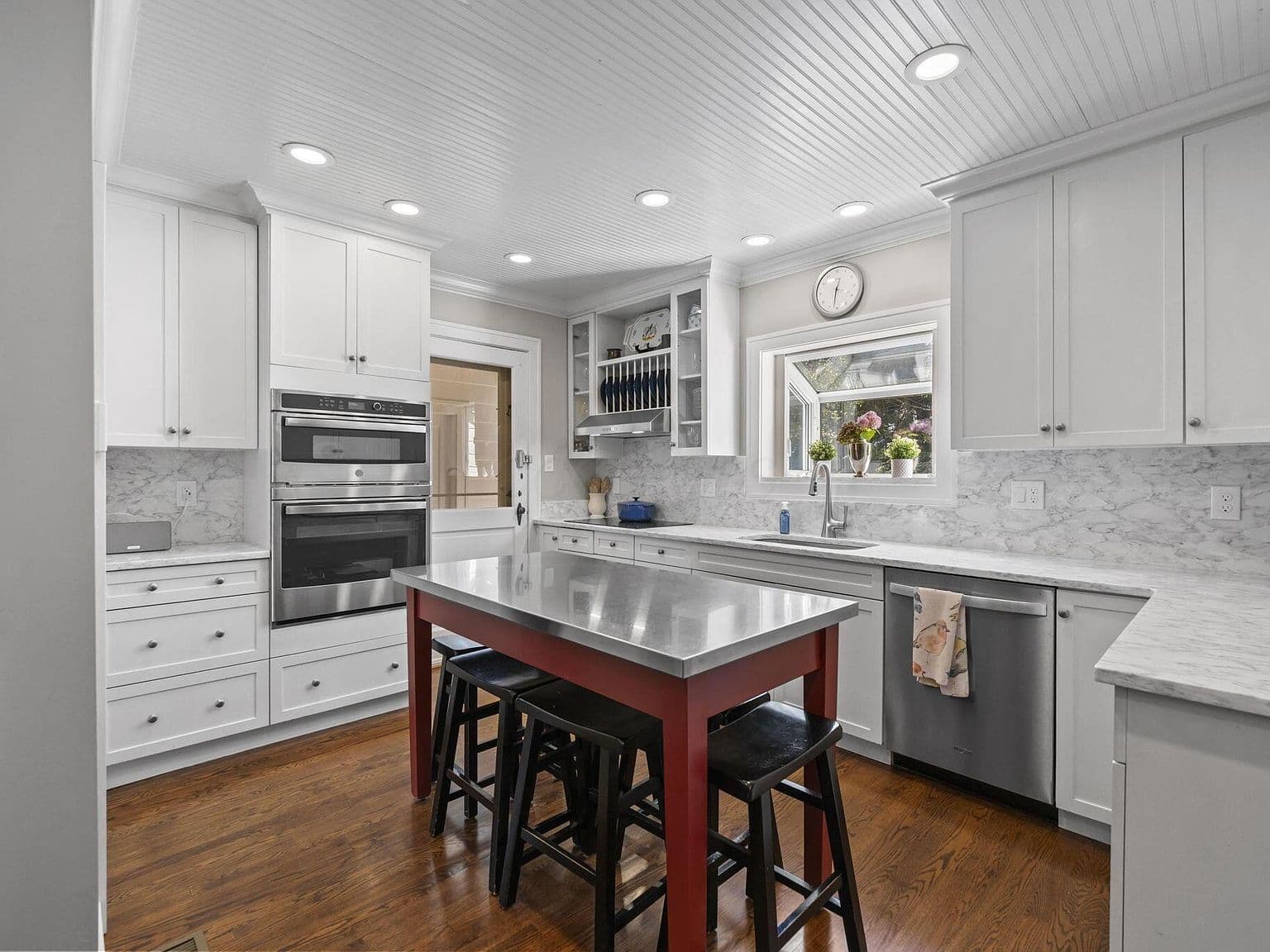 Bright kitchen showcases abundant cabinetry and stainless appliances.
