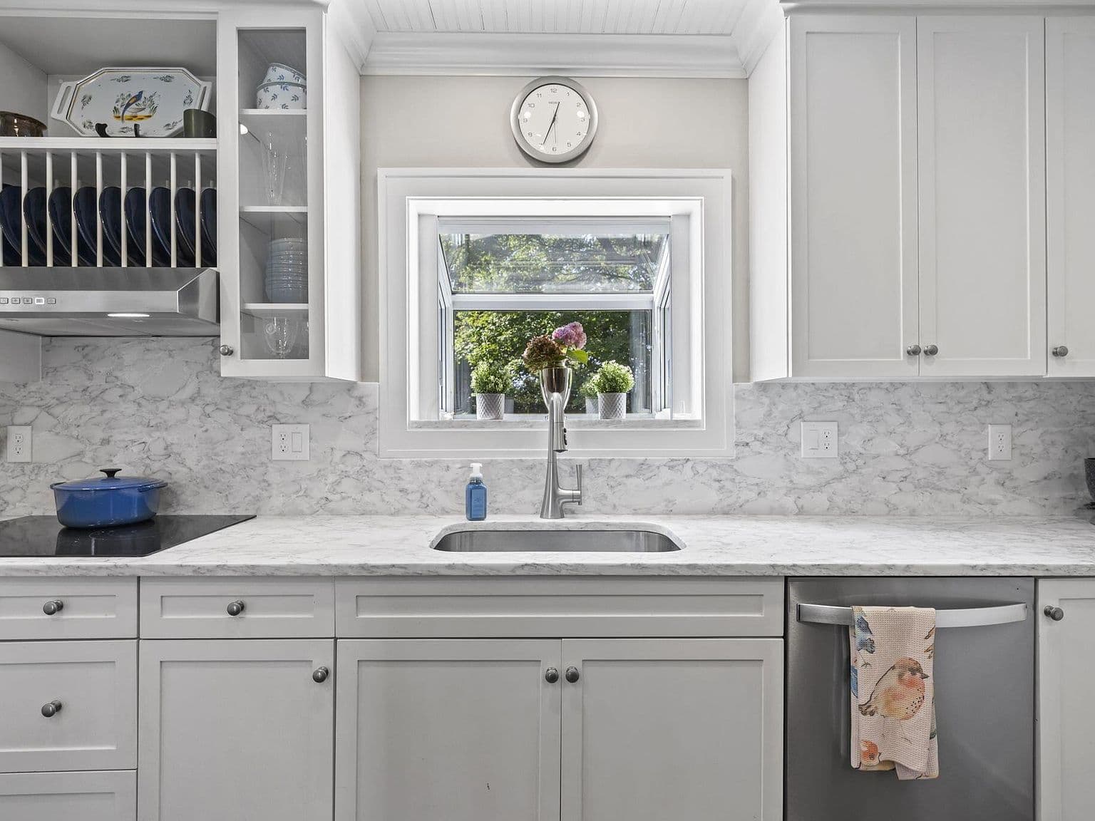 Picture window above sink brings in leafy views.