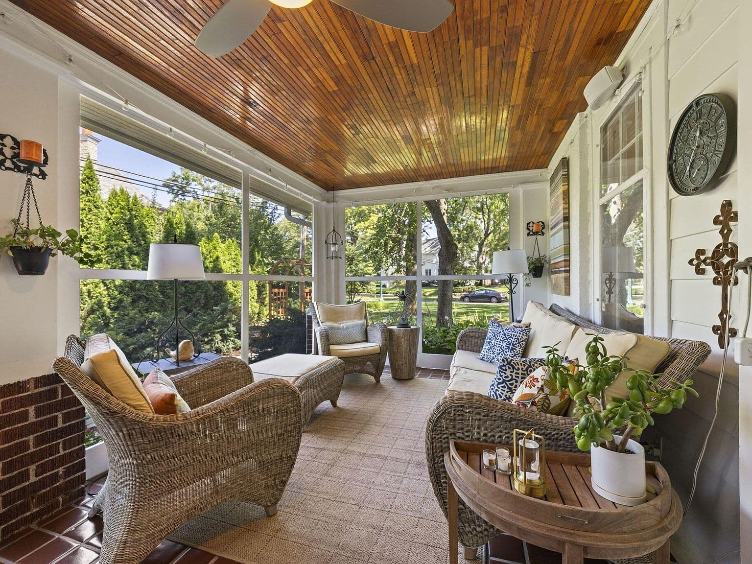 Relaxing screened porch lounge for breezy evenings outdoors.