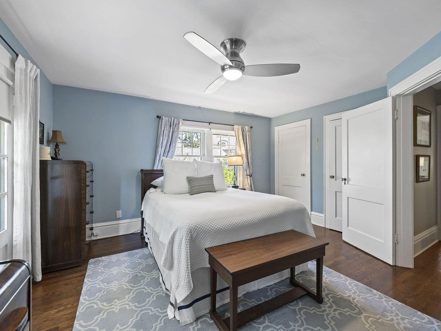 Cozy blue bedroom with hardwoods and classic trim.