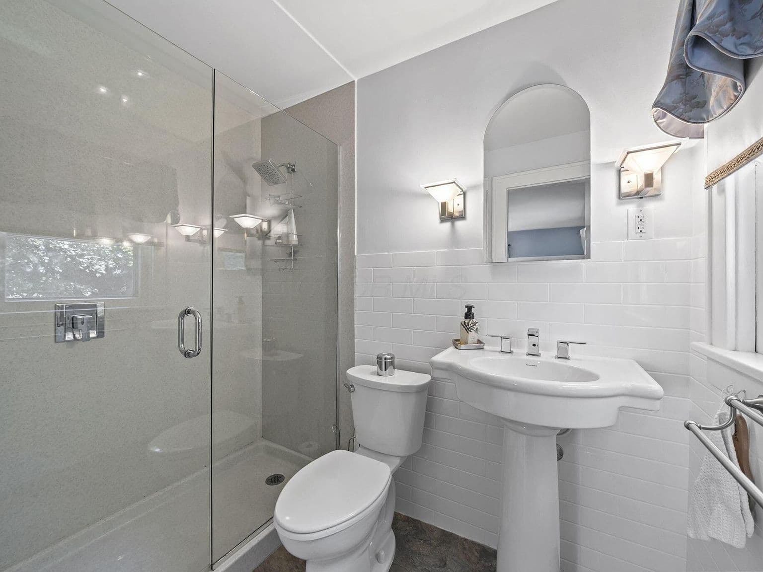 Crisp bath with glass shower and timeless subway tile.