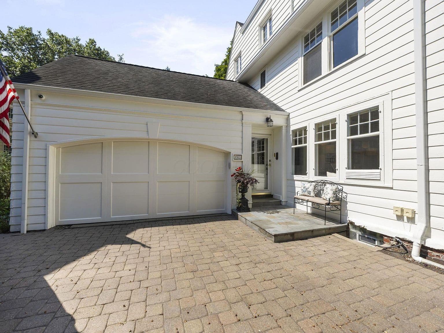 Attached two-car garage and charming side entry courtyard.