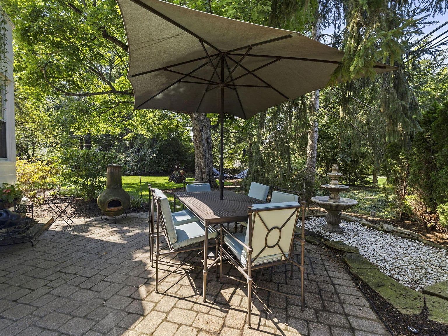 Shaded dining patio with fountain—perfect for outdoor entertaining.