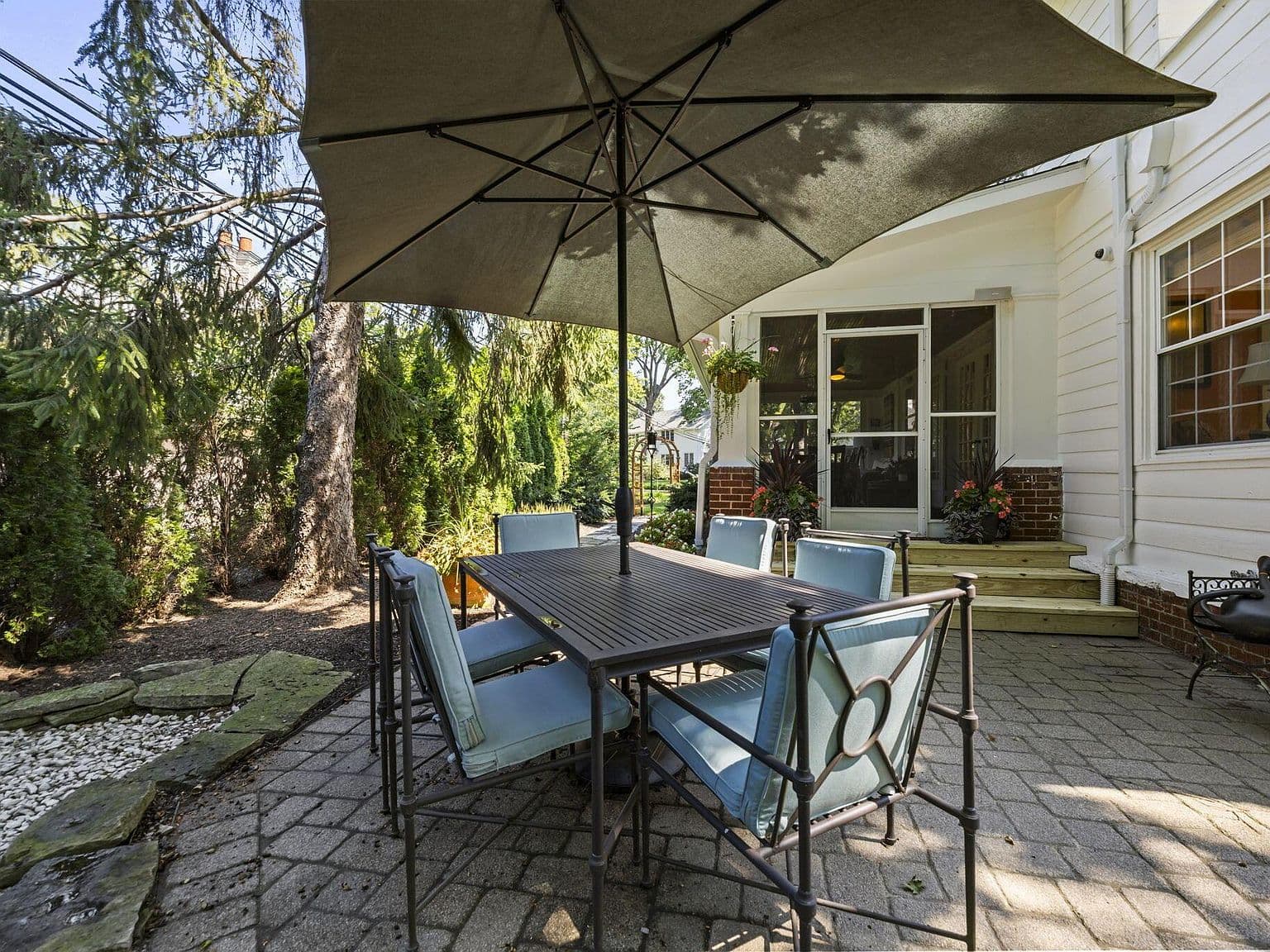 Relaxed outdoor dining steps from the screened porch.
