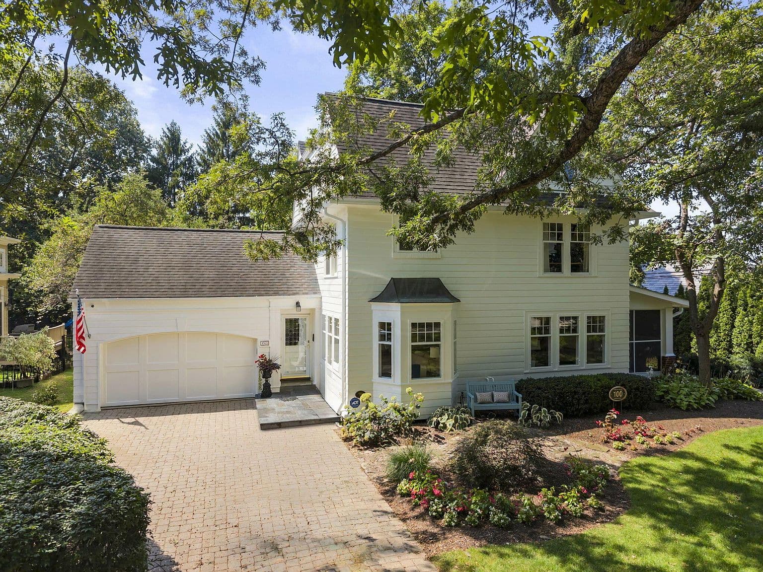 Classic exterior with attached two-car garage and inviting entry.
