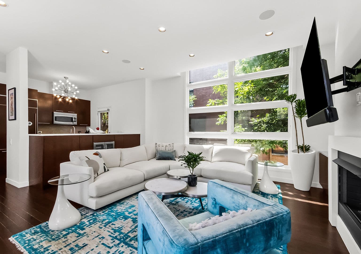 Floor-to-ceiling windows showcase leafy views and airy living.