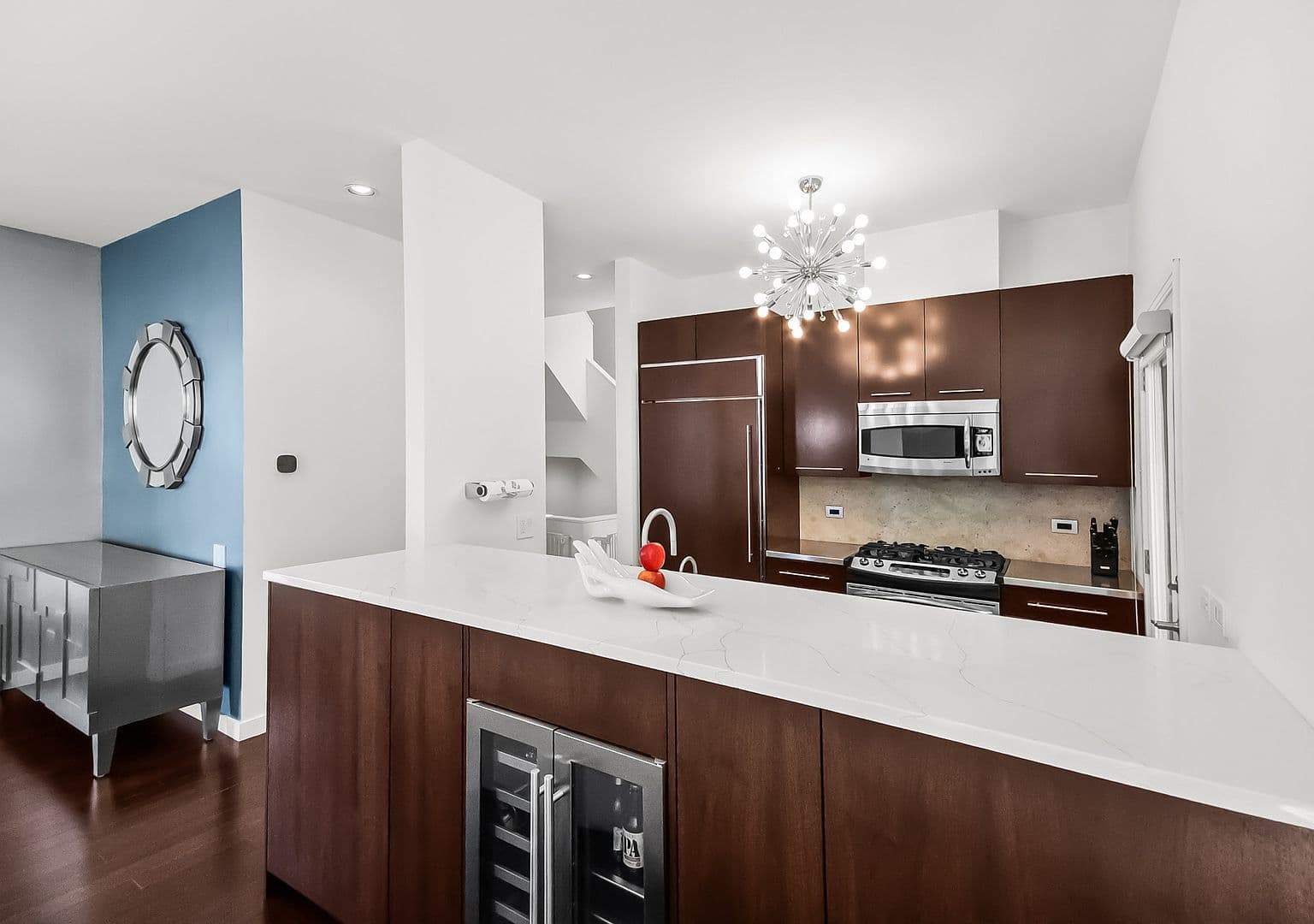Renovated chef’s kitchen with quartz island and premium appliances.