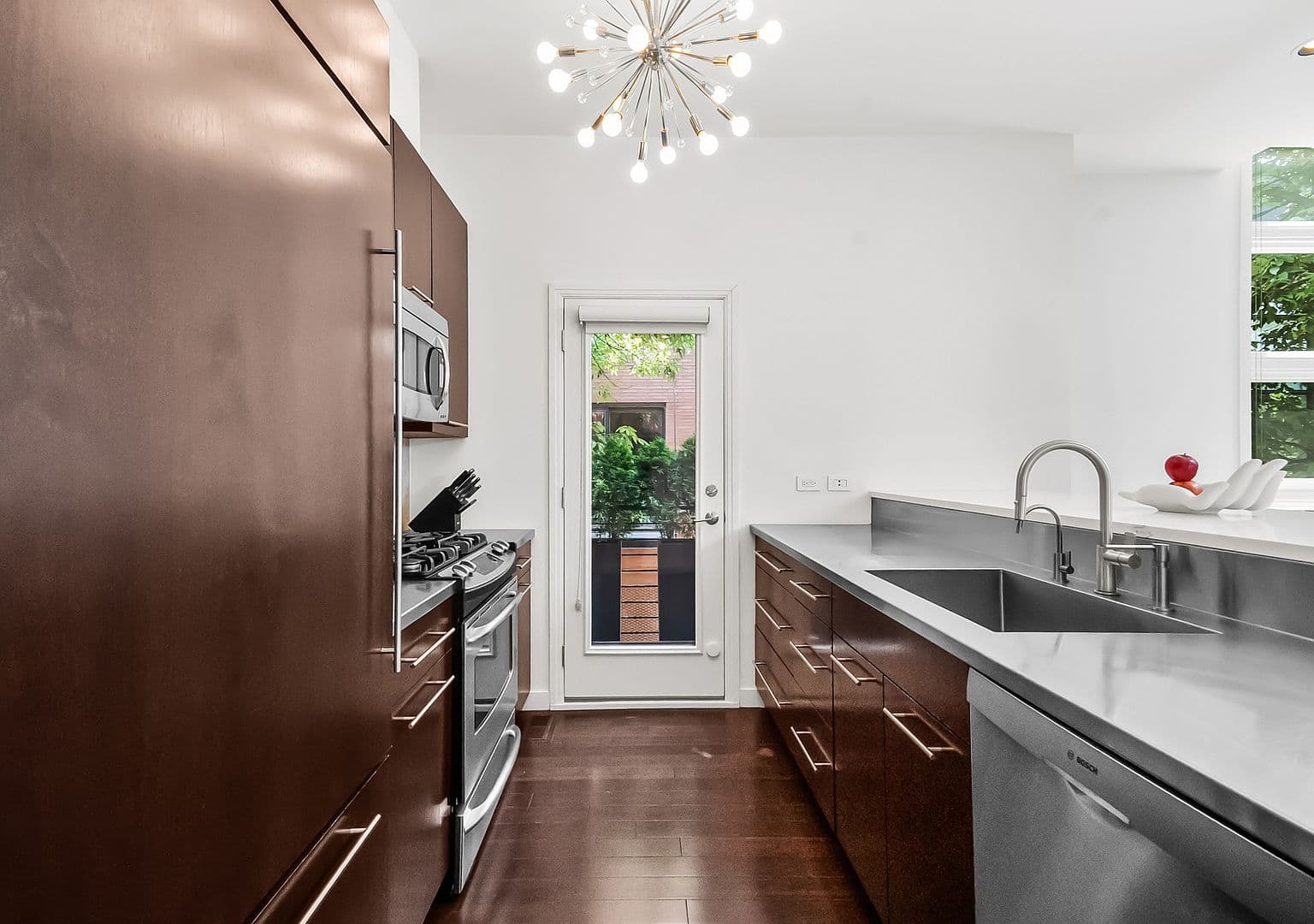 Streamlined galley kitchen featuring Bosch dishwasher and deep sink.