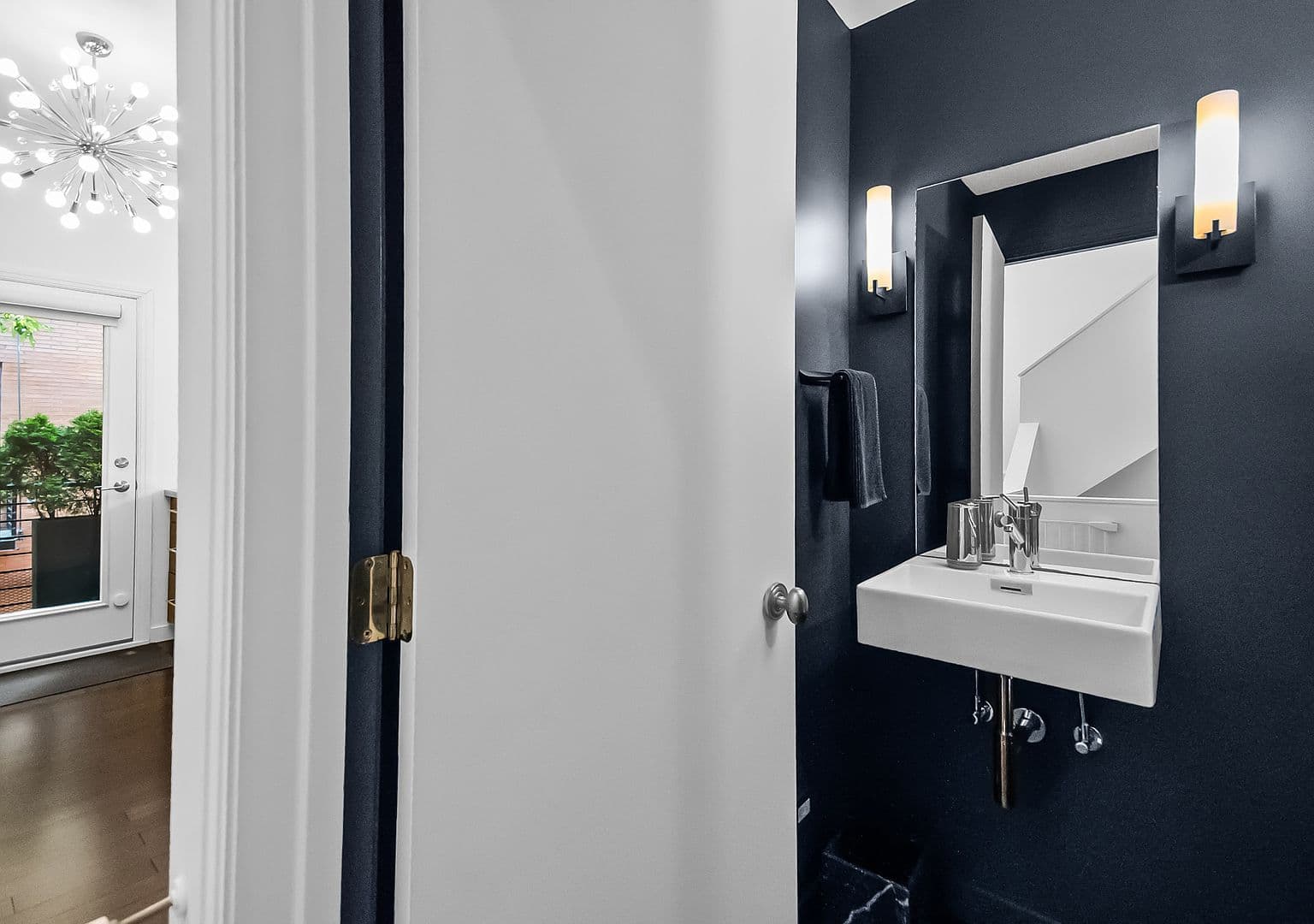 Stylish powder room with modern fixtures and dramatic accents.