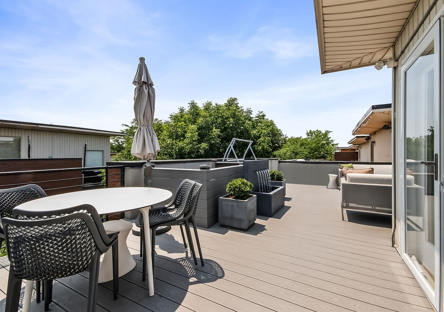 Rooftop dining area for summer meals under open skies.