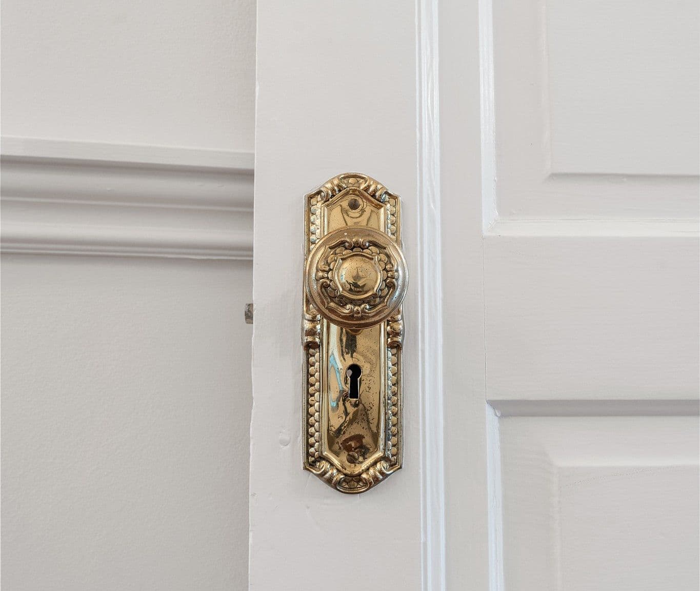 Ornate brass hardware highlights the home’s historic charm.