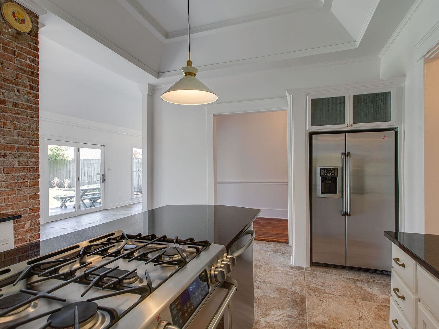 Chef-ready kitchen with gas range, granite, and backyard access.