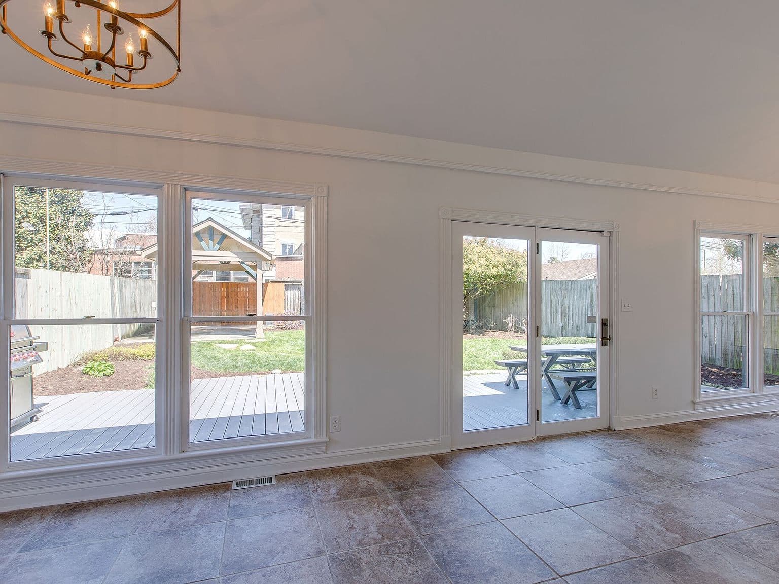 Bright great room opening to deck and fenced yard.