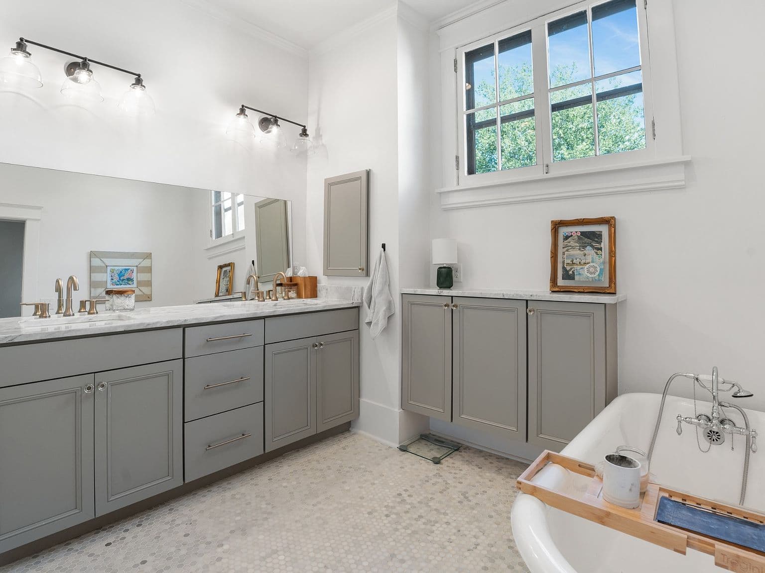 Spa-inspired bath with marble vanity and soaking tub.